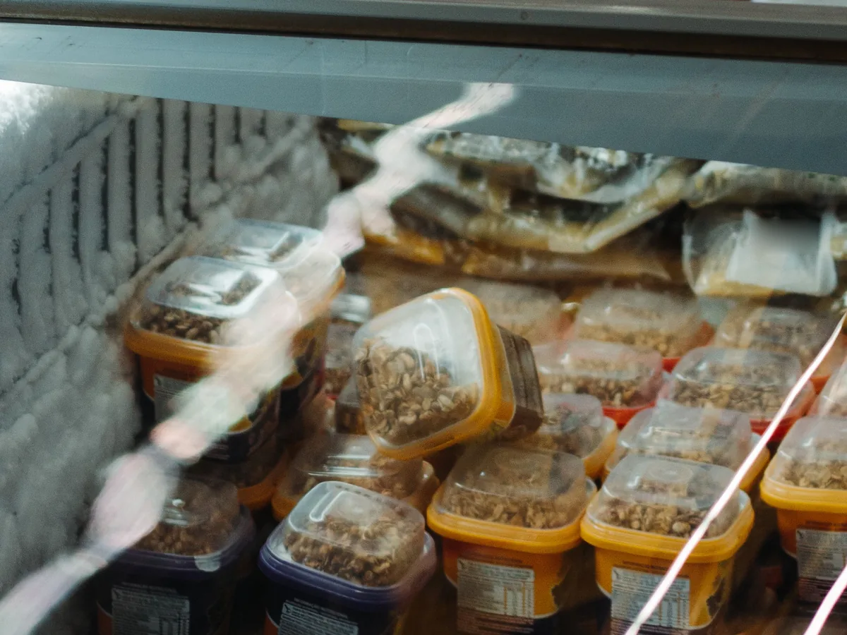 Frozen food in a supermarket's chest freezer, seen through the glass lid