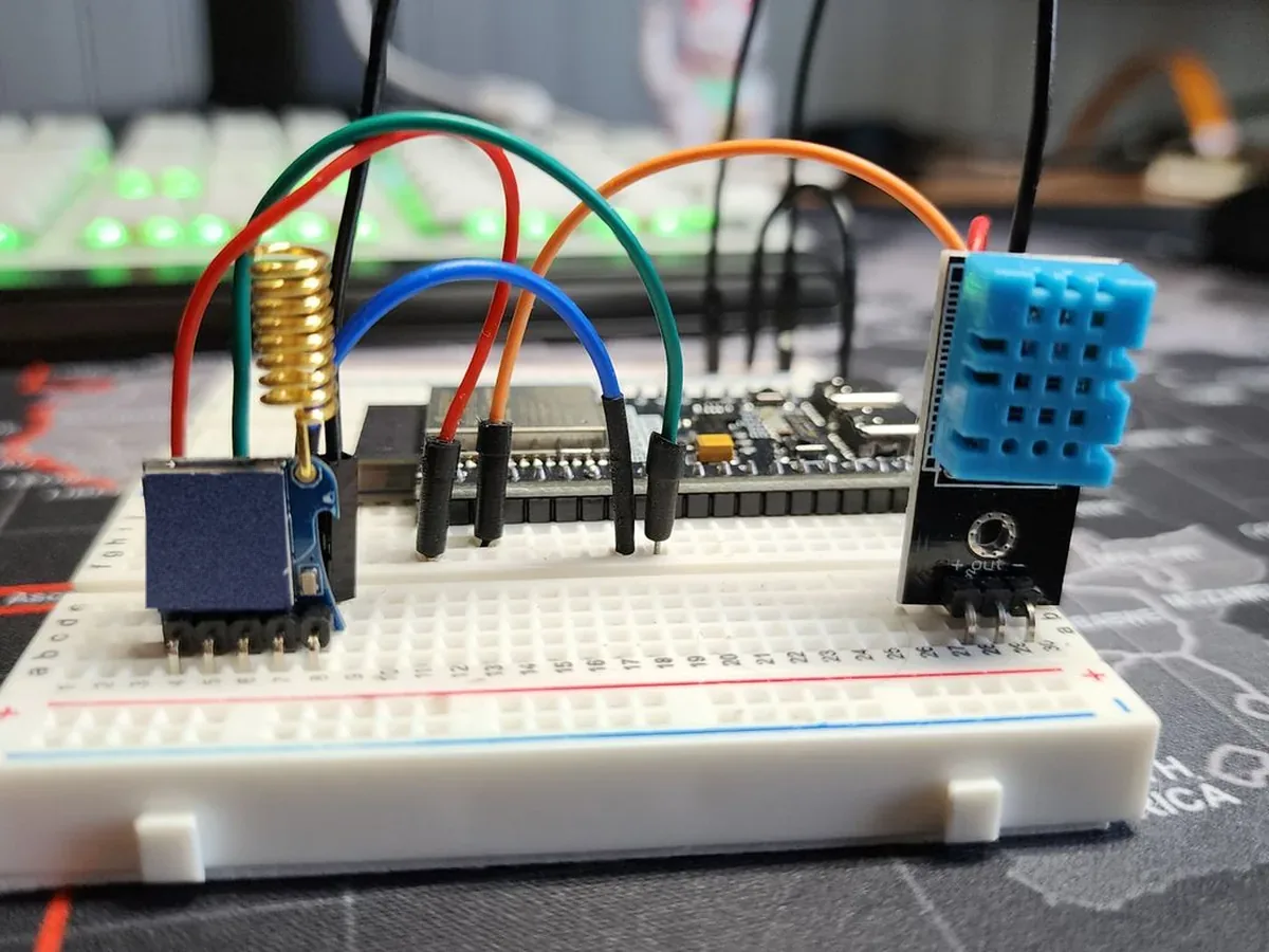 A working prototype on a breadboard: a radio module and a temperature sensor wired to a board
